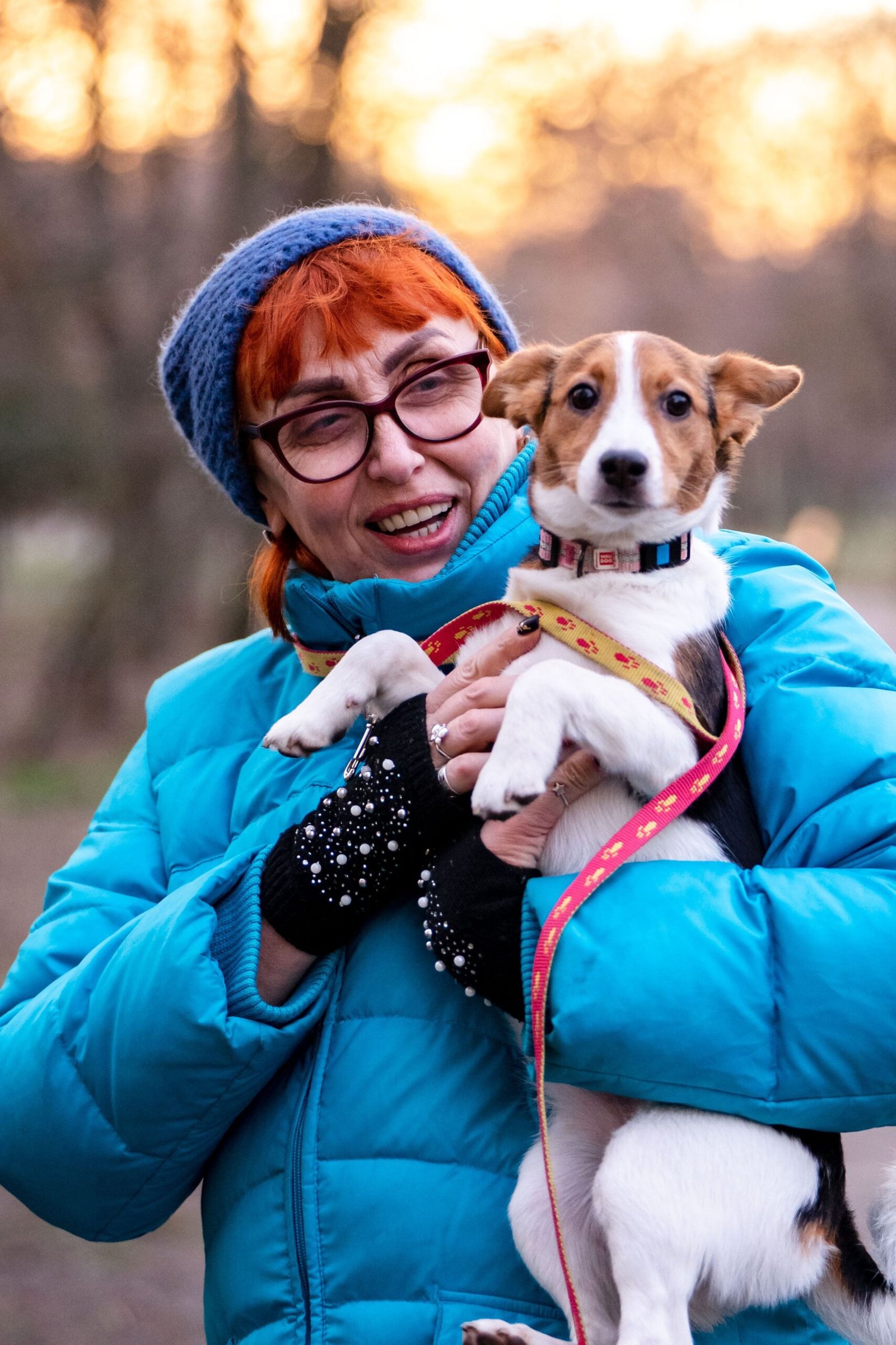 Owner holding a Jack Russell terrier puppy outdoors